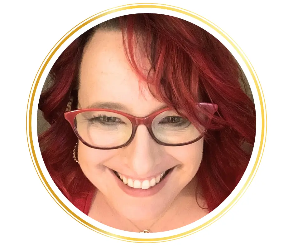 caucasian woman with red hair and red glasses smiling headshot