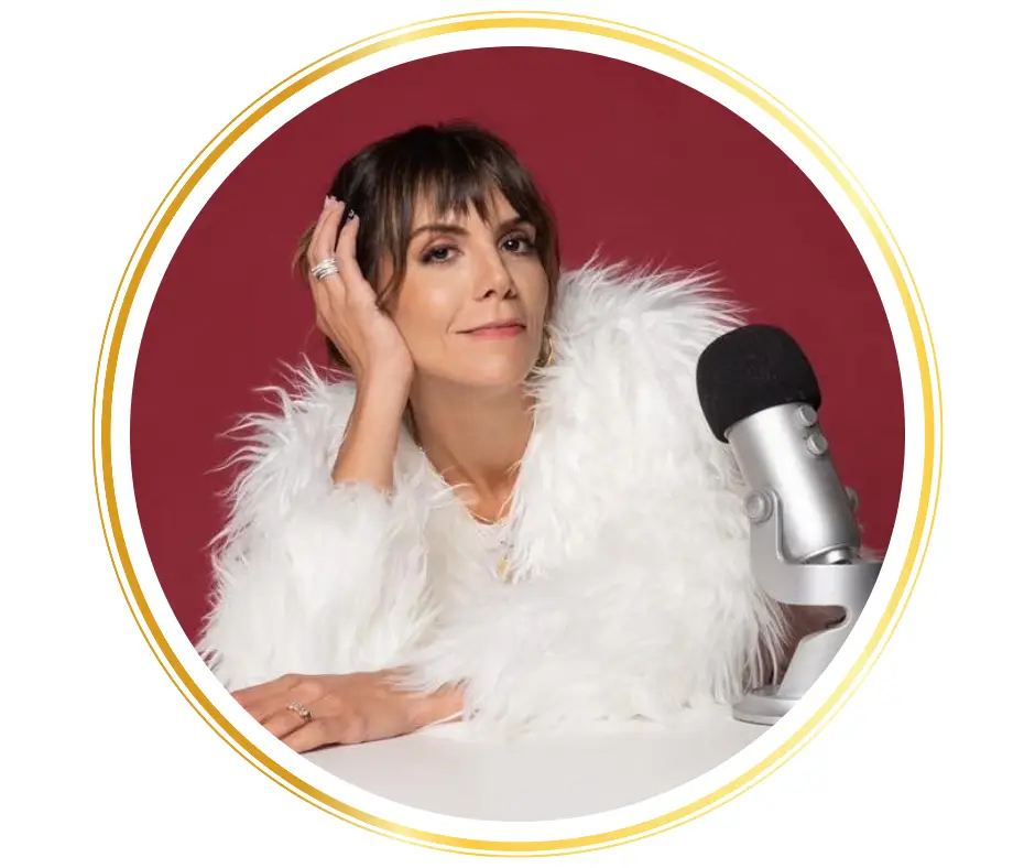 caucasian woman wearing a furry top sitting in front of a microphone